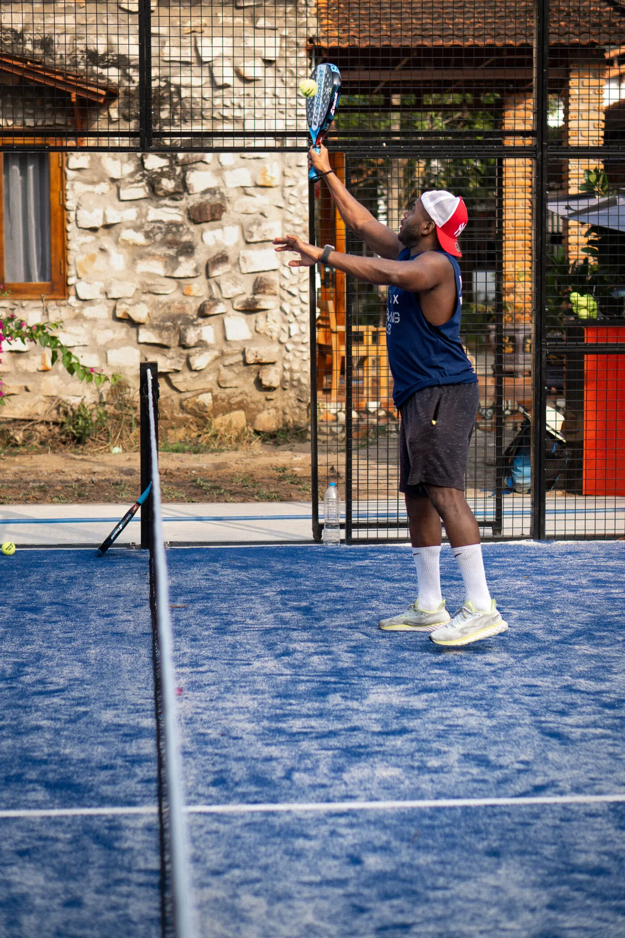 Padel serve on the blue court